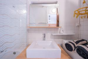 a white bathroom with a sink and a shower at Rose Des Neiges in Valloire +12 photos