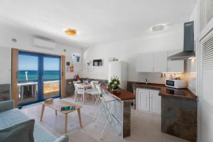 a kitchen and living room with a view of the ocean at Apartamentos Playa Azul - 3 in Vallehermoso