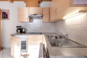 a kitchen with a sink and a counter top at Heinzenhof Welschnofen in Nova Levante +100 photos