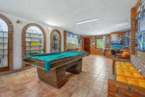a room with a pool table in it at Villa Leonor con piscina privada in Monachil