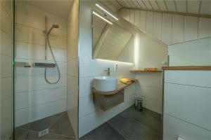 a bathroom with a sink and a shower at Kornbauernhof in Oberharmersbach +21 photos