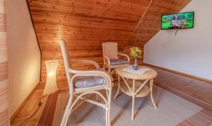 a room with a table and chairs and a tv at Kornbauernhof in Oberharmersbach