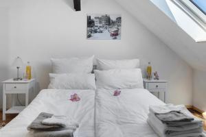 a bedroom with a white bed with towels on it at Ferienwohnung Birgit in Dessau