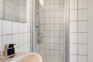 a bathroom with a sink and a shower at Ferienwohnung Birgit in Dessau +14 photos