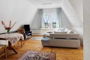 a living room with a couch and a table at Ferienwohnung Birgit in Dessau