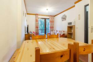a large wooden table in a living room at Appart valfrejus in Modane