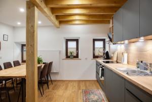 a kitchen with a table and a dining room at Ferienwohnung Piburgersee in Oetz