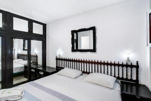 a bedroom with a bed and a mirror on the wall at Los Molinos 538 in Maspalomas