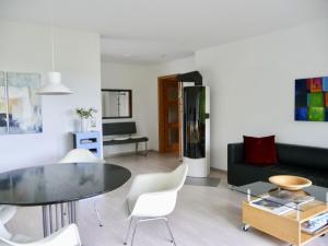 a living room with a table and a couch at Haus am See in Illmensee +30 photos
