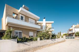 a house with a fence in front of it at Velvet Apartments in Rhodes Town