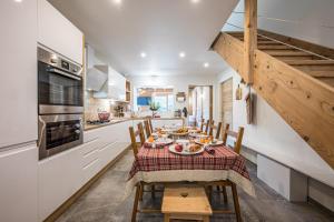 a kitchen and dining room with a table and chairs at La scierie de la grande ourse in Albiez-Montrond