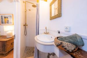 a white bathroom with a sink and a mirror at Casa Max in Artá +23 photos