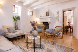 a living room with a couch and chairs and a fireplace at Casa Max in Artá