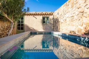a house with a swimming pool next to a building at Casa Max in Artá