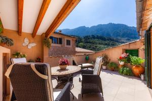an outdoor patio with a table and chairs at Can Murons in Fornalutx