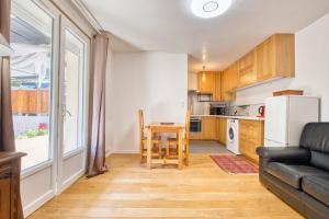 a kitchen and dining room with a table and a couch at L'appartement d'Olympe in Périgueux