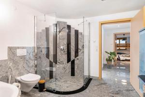 a bathroom with a shower and a toilet at Ferienwohnung Nearby in Thüringen +36 photos