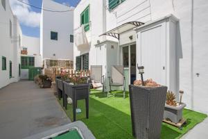 a patio with grass and plants on a building at Casa Fabi in Arrieta