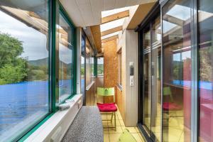 a room with windows and a balcony with a view at bei den Holzäppeln in Völkersweiler