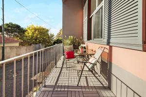 a patio with chairs and a table on a balcony at Calheta Lofts I in Calheta