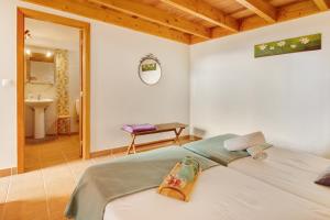 a bedroom with a bed and a bathroom at Calheta Lofts I in Calheta
