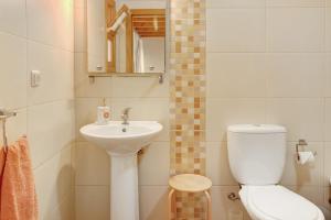 a small bathroom with a toilet and a sink at Calheta Lofts I in Calheta +20 photos