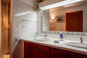 a bathroom with two sinks and a large mirror at Les Cigales in Ceyreste +15 photos