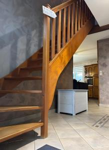 a wooden staircase in a living room at Chambres D'hôtes in Videcosville