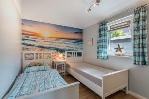 a small bedroom with a bed and a window at Nordlicht in Fehmarn