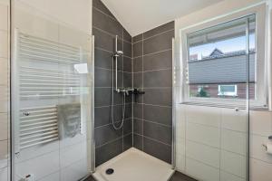 a bathroom with a shower with a glass door at Nordlicht in Fehmarn +21 photos