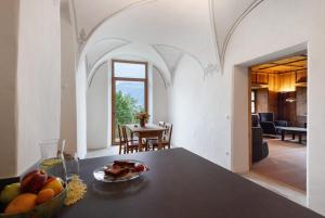 a kitchen with a table with a bowl of fruit on it at Ansitz Baumannhof Apt 1818 in Falzes +31 photos