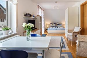 a living room with a table and chairs and a bedroom at Ferienwohnung Ingrid Heyes in Radolfzell am Bodensee