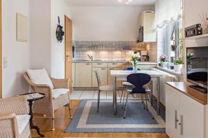 a small kitchen with a table and chairs at Ferienwohnung Ingrid Heyes in Radolfzell am Bodensee +19 photos