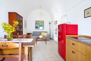 a kitchen and living room with a red refrigerator at Casina delle Rose - Scirocco in Polignano a Mare
