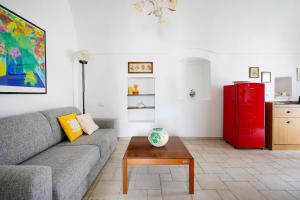 a living room with a couch and a red refrigerator at Casina delle Rose - Scirocco in Polignano a Mare