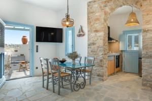a kitchen and dining room with a table and chairs at Sylvia's Home in Sifnos