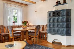 a dining room with a table and a fireplace at Ferienhaus Blumenstock in Steinsfeld