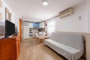 a bedroom with a bed and a television and a table at Noria 2 in Níjar