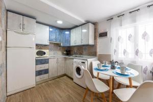 a kitchen with a table and a washer and dryer at Noria 2 in Níjar