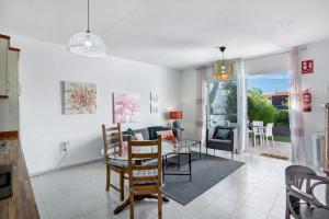 a dining room and living room with a table and chairs at Casa Crater 3 in El Paso