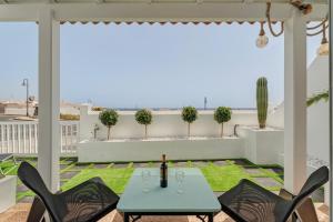 a patio with a table and chairs and a view of the ocean at Morgana in Abades