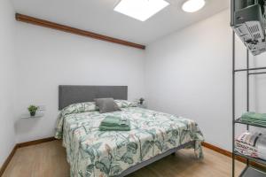 a bedroom with a bed in a white room at La Gomera in La Victoria de Acentejo