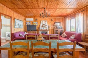 a living room with a table and a couch at Casa las Olivas in Sayalonga