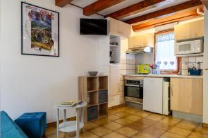 a small kitchen with a blue couch and a table at Gite Riesling n°5 à Kaysersberg in Kaysersberg