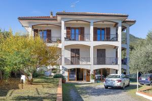 a house with a car parked in front of it at Villa Cristina - vista mare in Boissano