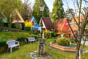 a garden with a bench and a light pole at Gite Riesling n°5 à Kaysersberg in Kaysersberg +17 photos