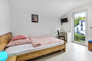 a bedroom with a bed and a desk and a window at Haus mit 4 Schlafzimmern in Solingen