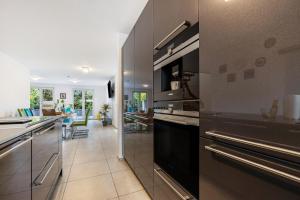 a kitchen with stainless steel appliances and a living room at Haus mit 4 Schlafzimmern in Solingen