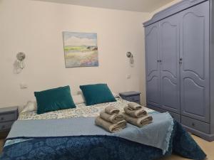 a bedroom with a bed with towels on it at Casa Paula - 12 in Arinaga +10 photos