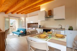 a kitchen and living room with a table and chairs at Vico degli Orti in Mistretta